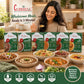 A woman smiling while eating a Curriies4u ready-to-eat meal, surrounded by various Indian curry pouches and bowls.